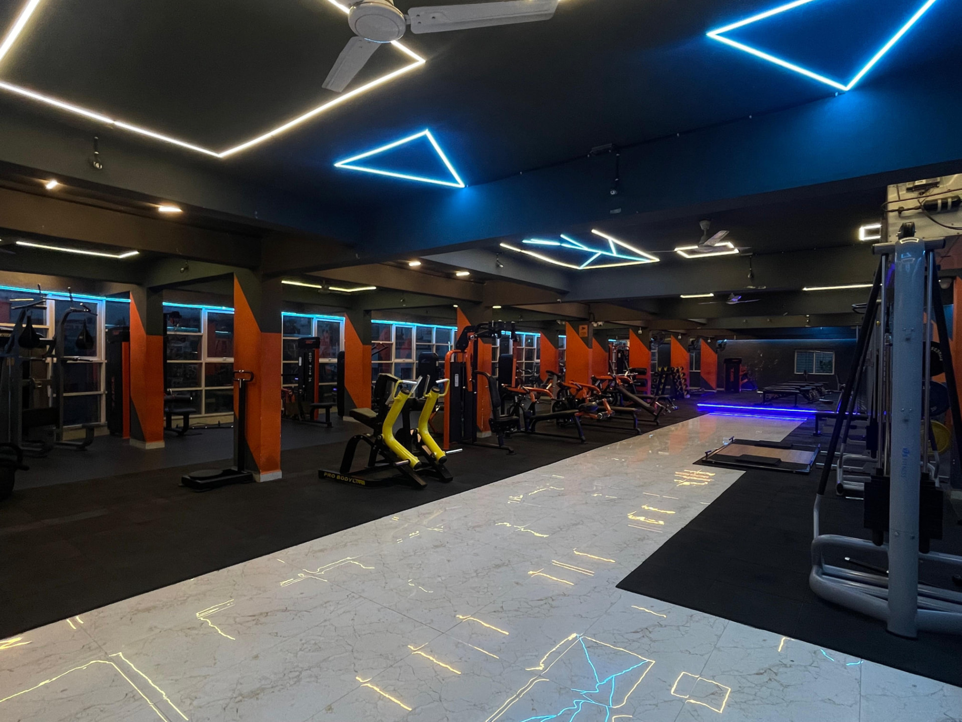 Wide view of the plate-loaded equipment section on the main training floor of SK Fitness Gym Kharadi, Pune Wide view of the plate-loaded equipment section on the main training floor of SK Fitness Gym Kharadi, Pune