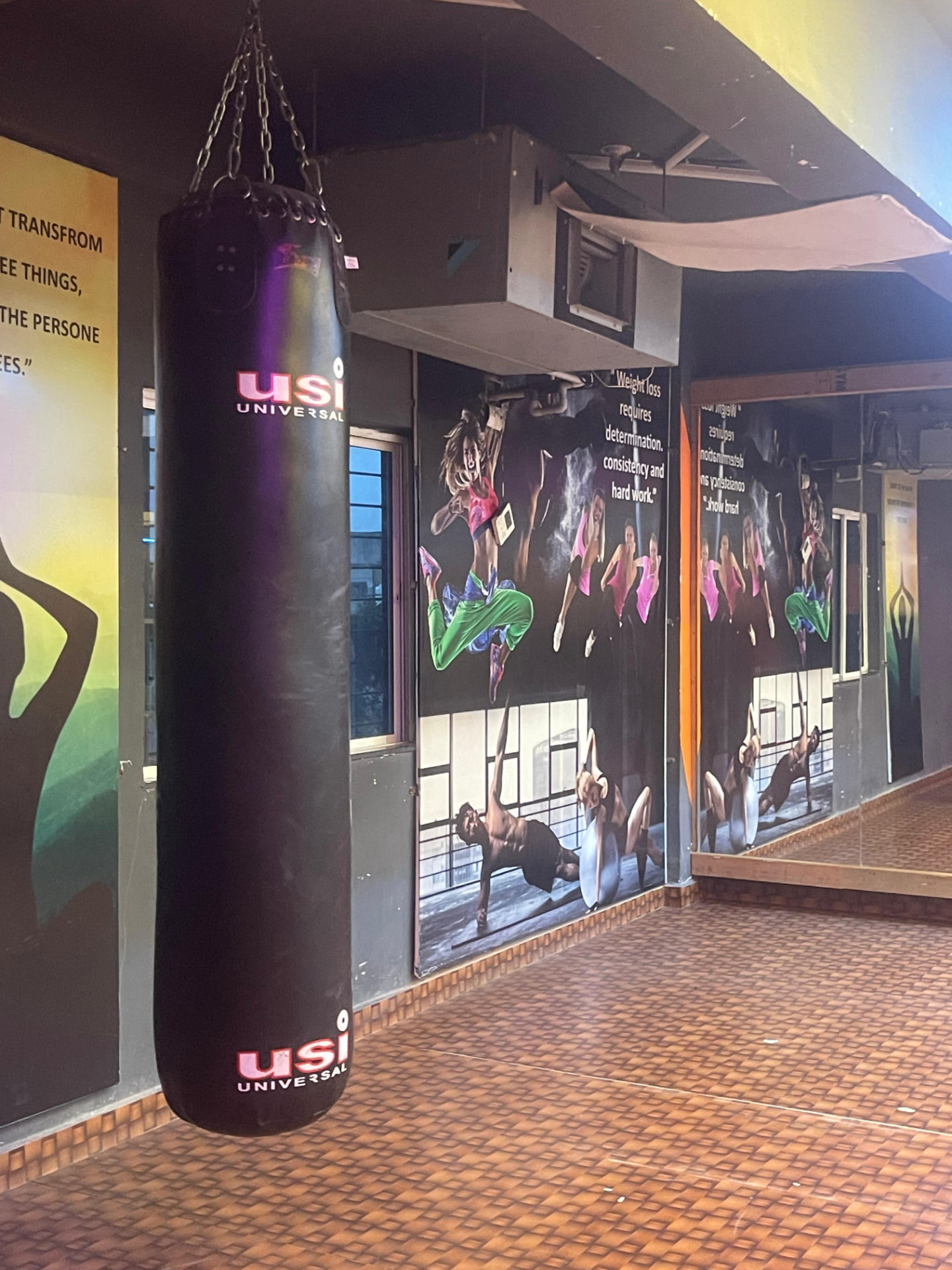 Heavy punching bag and motivational wall graphics in the functional training studio at SK Fitness Gym Kharadi Heavy punching bag and motivational wall graphics in the functional training studio at SK Fitness Gym Kharadi