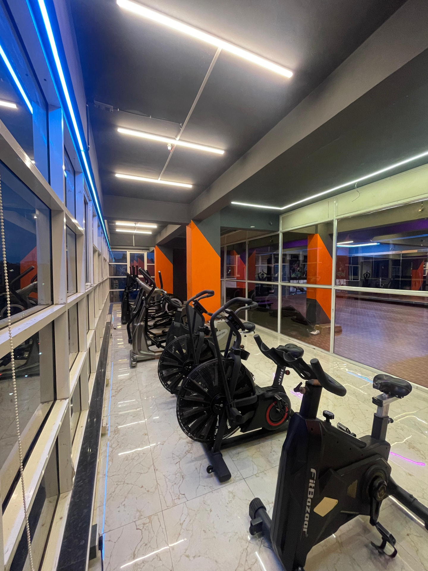 Spin bikes and air bikes beside the window in the cardio zone of SK Fitness Gym Kharadi, Pune Spin bikes and air bikes beside the window in the cardio zone of SK Fitness Gym Kharadi, Pune