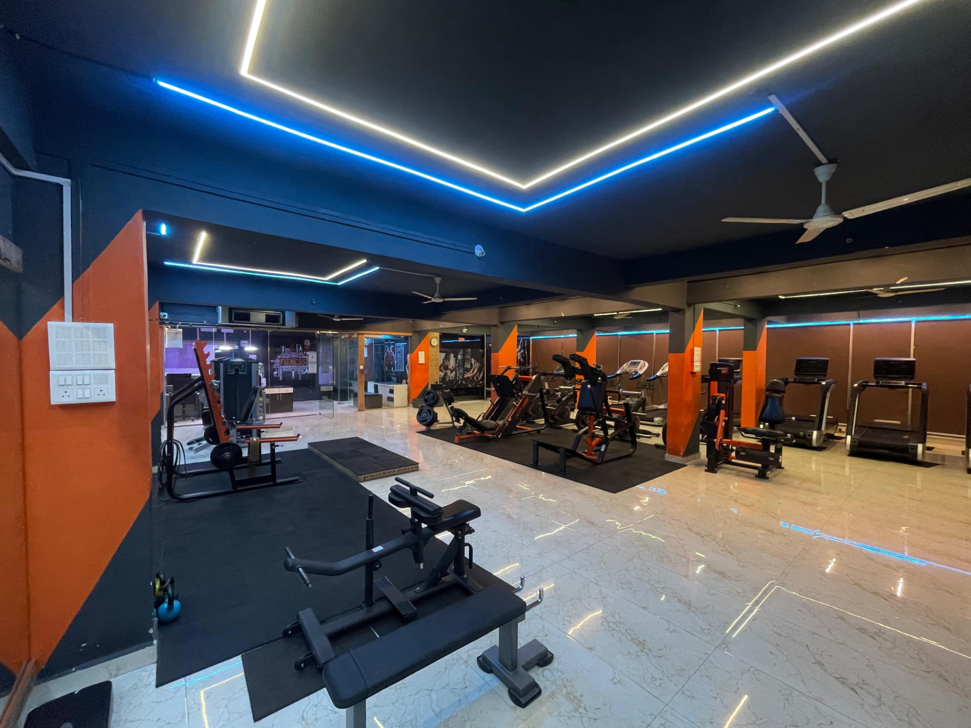 Main training floor with imported machines and LED ceiling lighting at SK Fitness Gym Kharadi, Pune