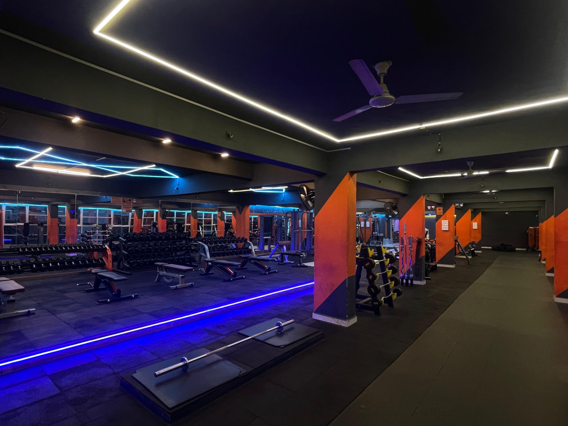Dumbbell racks facing a full mirrored wall in the strength hall at SK Fitness Gym Kharadi, Pune Dumbbell racks facing a full mirrored wall in the strength hall at SK Fitness Gym Kharadi, Pune